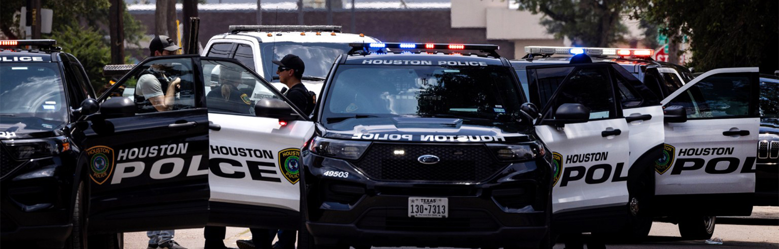 Houston police officers with police cars talking to each other